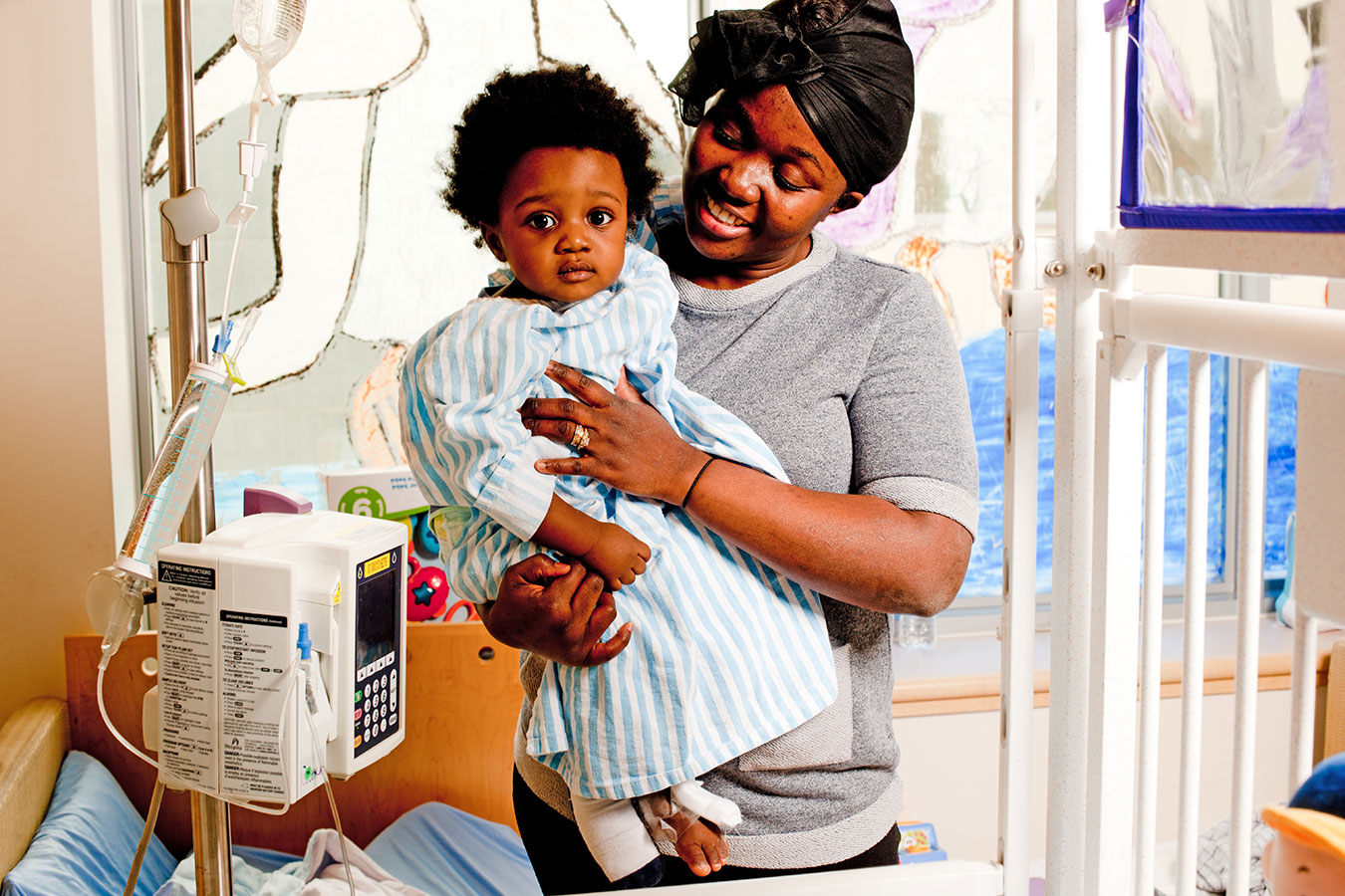 Mother holding toddler in paediatric room
